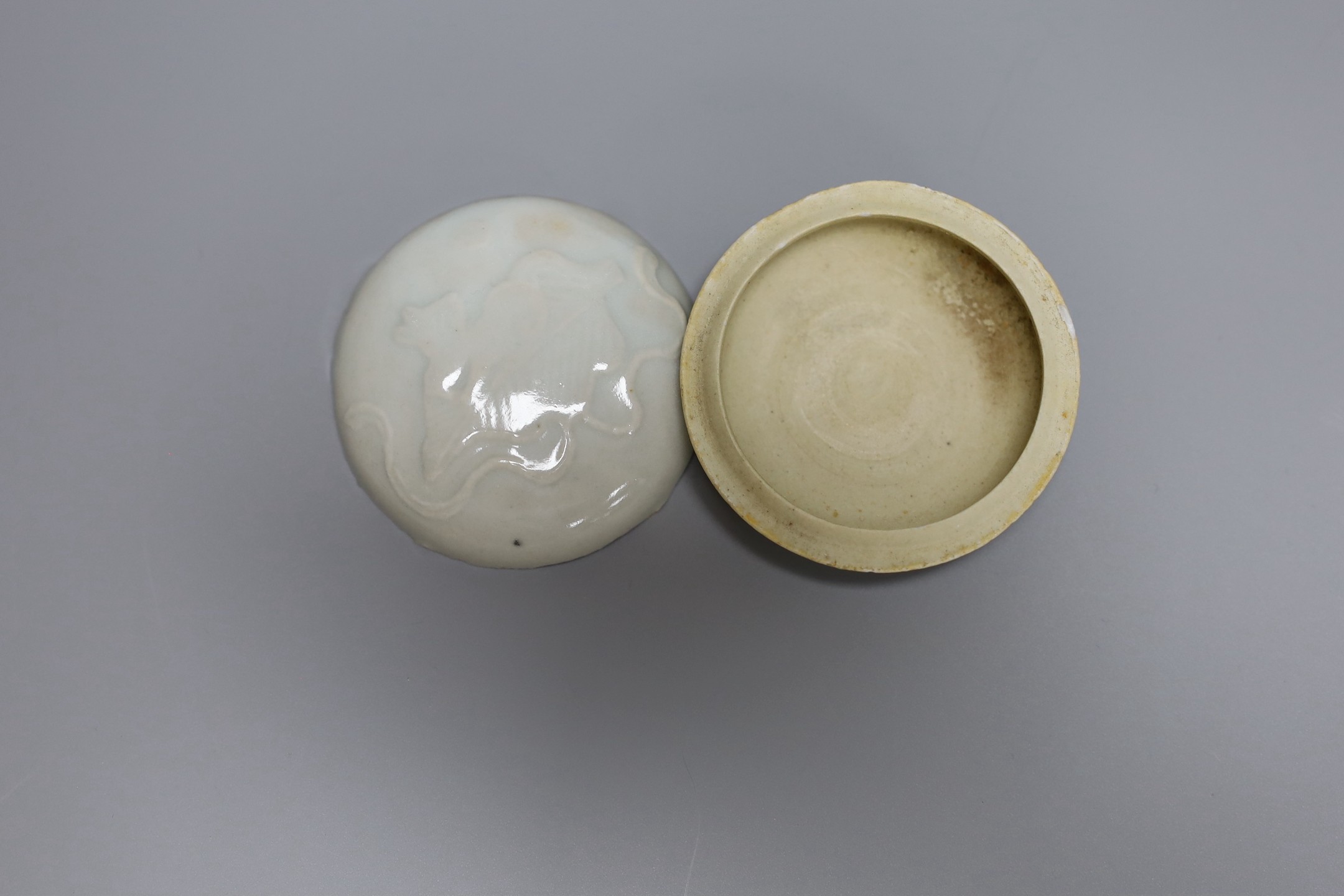 A Chinese celadon ground bottle vase, a similar crackle glazed vase, a paste box with cover and stand, tallest 16cm